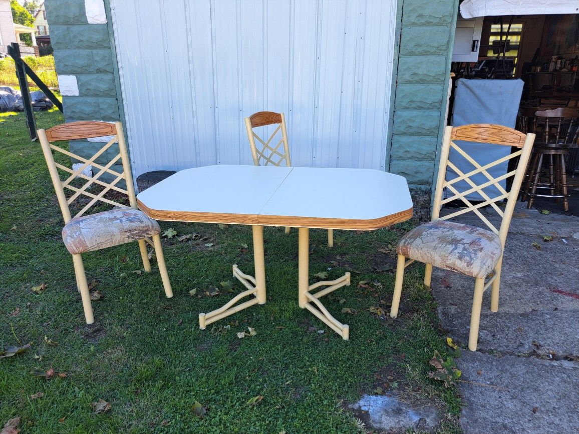 Formica Top Table and Three Cushioned Fabric Steel Chairs.
