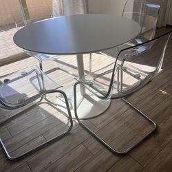 CB2 White circular dining Table With Four Ikea Chairs