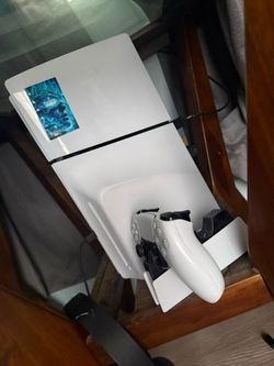 PS5 with 2 controllers,charging station, and headphones