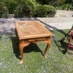 vintage wooden end table with Queen Anne-style legs and a single drawer with a brass pull handle.