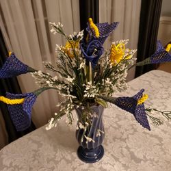 Artificial flowers with a blue vase