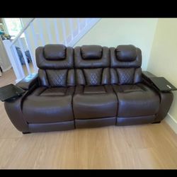 Leather sofa with recliner seats.