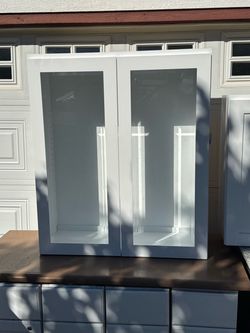 Pair upper shaker white cabinets with glass doors