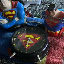 2 Statues Of Superman And A Clock