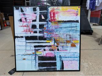 wall art is "Gio Grid I" by artist Robin Maria, featuring blue, pink, and yellow brushstrokes over a black background.