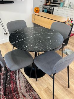 Black circular dining table & grey dining chairs