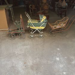 Three antique baby strollers