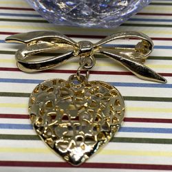 Elegant Vintage Bow Brooch with Dangling Pierced Heart Pendant, Love Lapel Pin in Gold Tone
