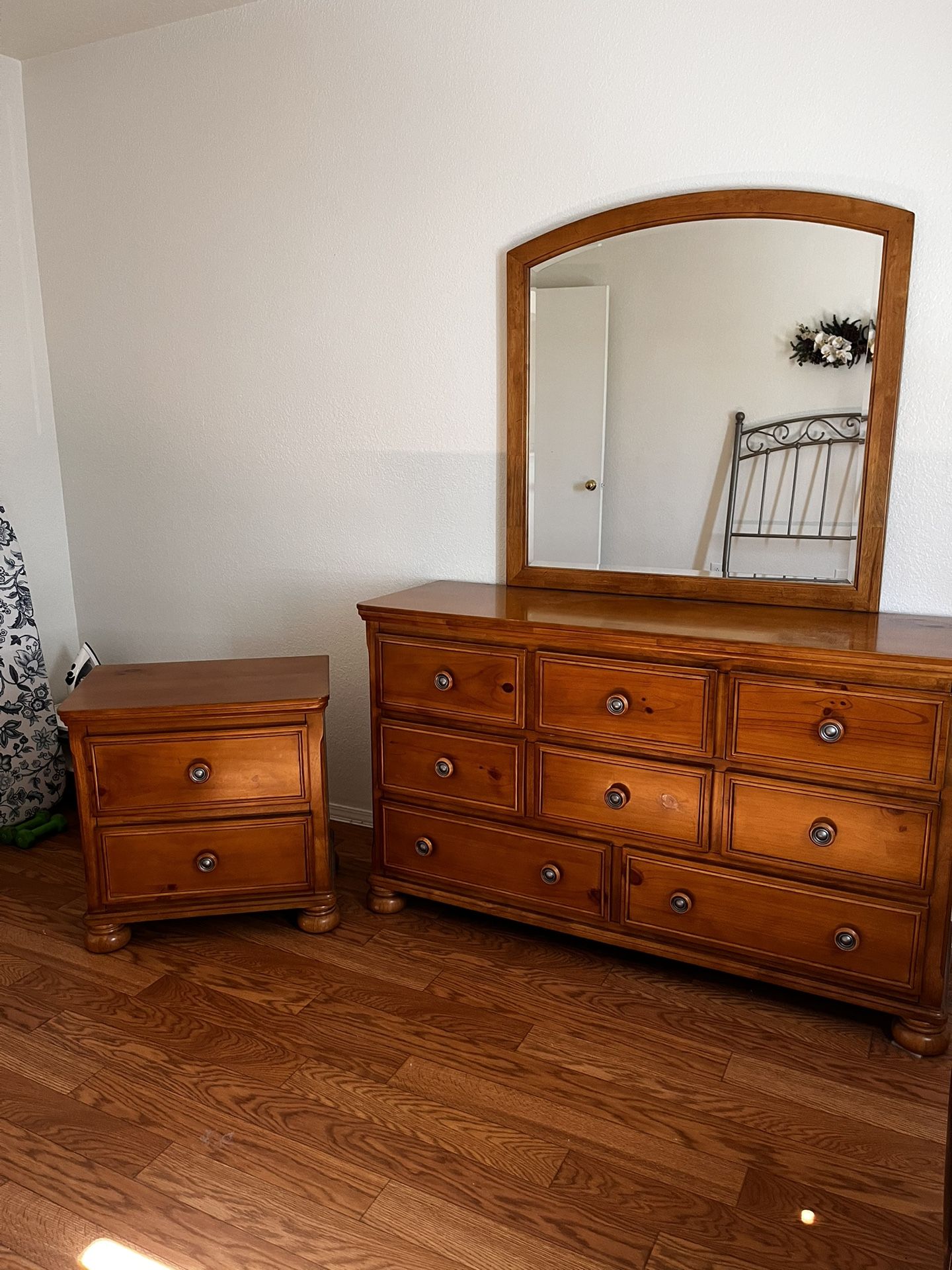 Dresser with a mirror and a matching nightstand.