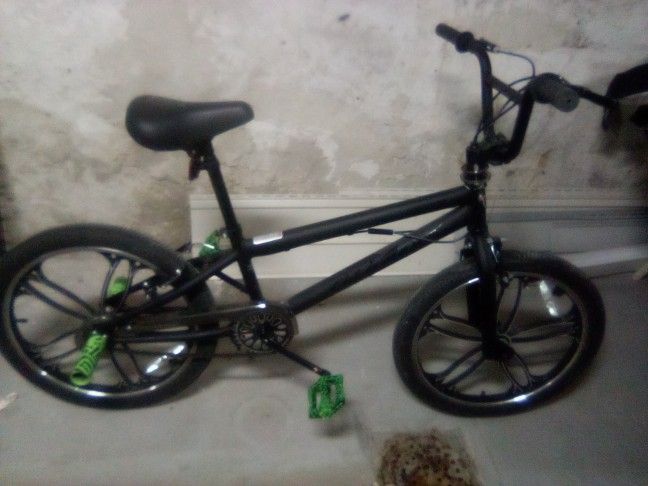 Two Teenagers Stunt Bikes
