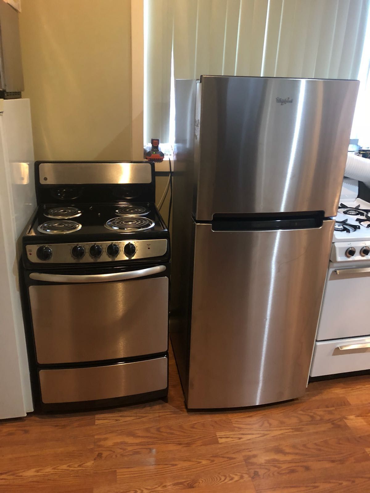 Whirlpool 24 inch wide refrigerator and GE 24 inch wide stove electric set