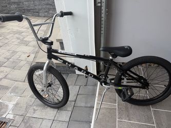 black Haro Shredder Pro 20 BMX bike with a 20.3-inch top tube, silver fork, and chrome handlebars.