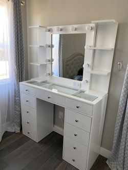 Vanity mirror and desk with glass top shelves diamond knobs and light bulbs