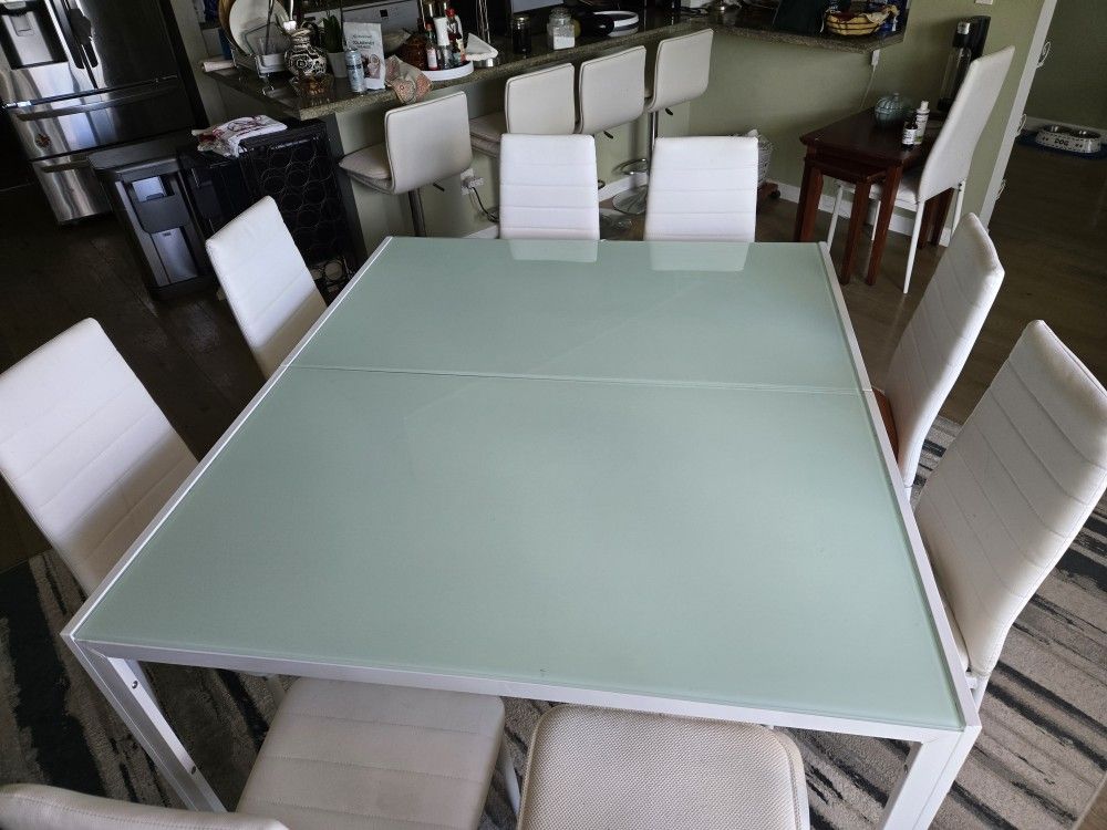 Duble glass table 8 wite chairs .
