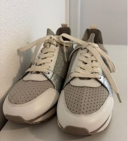 Michael Kors Women’s white, gray and silver sneakers size 6.