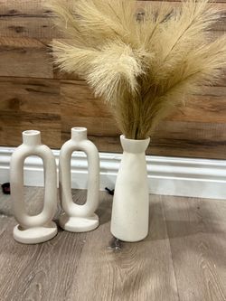 Two candle holders and one vase