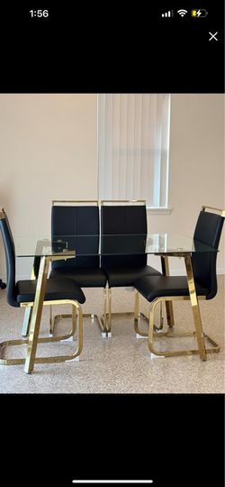 Glass table with black and gold chairs