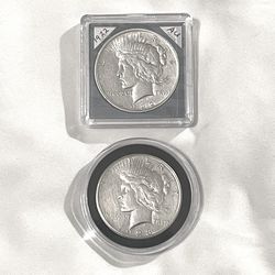 About uncirculated-AU(50)  sealed in capsules 1922 and 1923 piece silver dollars