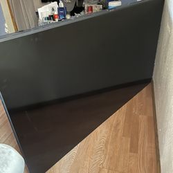 Samsung Tv. Two Purple Couches. Two Cabinets. One Mirror Attached To Cabinet. 