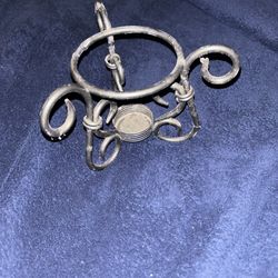 Vintage metal candle holder with triangular looping legs