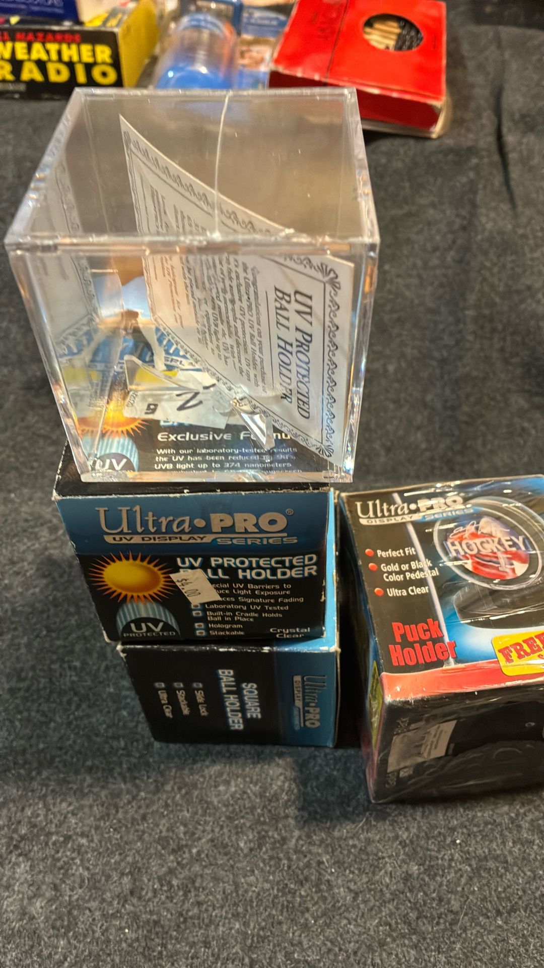 Brand new baseball and hockey puck holders