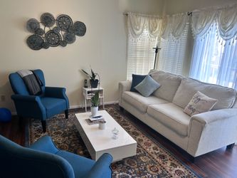 Comfy light beige sofa , 2 blue accent chairs and coffee table