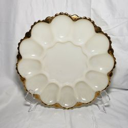 VIntage Anchor Hocking Fireking milk glass with gold trim deviled egg plate. Good condition and smoke free home.  Measures 10" across