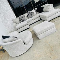 Grey fabric sectional with ottoman  And round swivel chaise