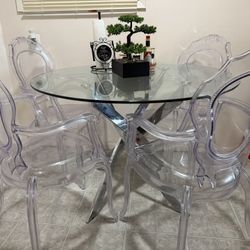 Glass top dining table with four chairs