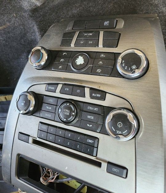 Radio and climate control panel for a 2010-2012 Ford Fusion.