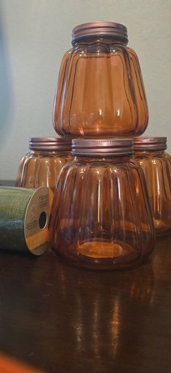 Glass "pumpkin" jars (4) and green ribbon