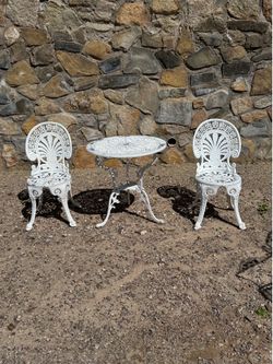 Gorgeous antique bistro set of 3 piece. Chairs and table is all metal. Sell as is, West