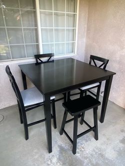 Table three chairs and a small bench