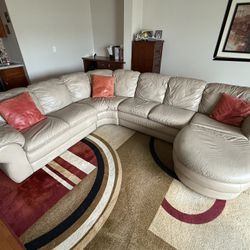 Beige Leather Couch And 12.5W X 9H Design Area Rug. 