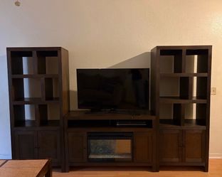 Entertainment center with fire place and TV
