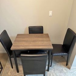 Slightly used dining table with 4 chairs
