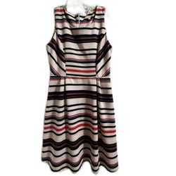 Elegant sleeveless dress by Gibson Latimer with a soft cream background and horizontal black, soft red, and subtle blue stripes. Flattering fit-and-fl