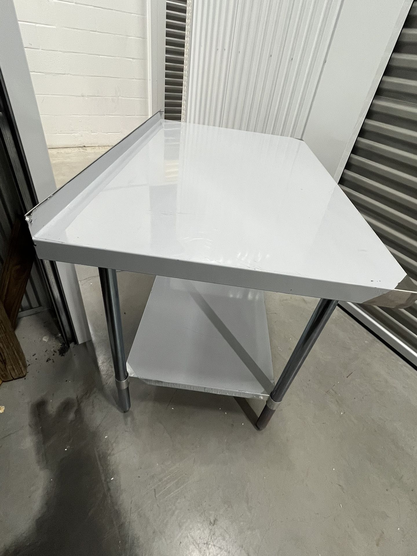 Stainless Steel Work Table 48W X 30D X 35H with 2” backsplash 