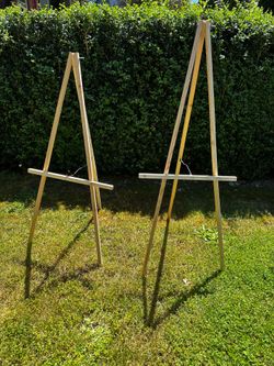 Two light unfinished wood easels/stands for signage