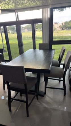 Dining table w/4 chairs and one bench to rooms to go