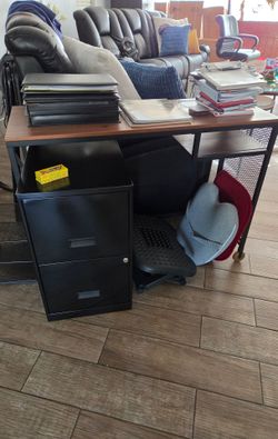 Small desk with chair and filing cabinet.