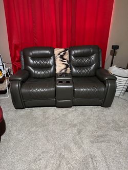 Gray leather rocker/recliner with storage consol