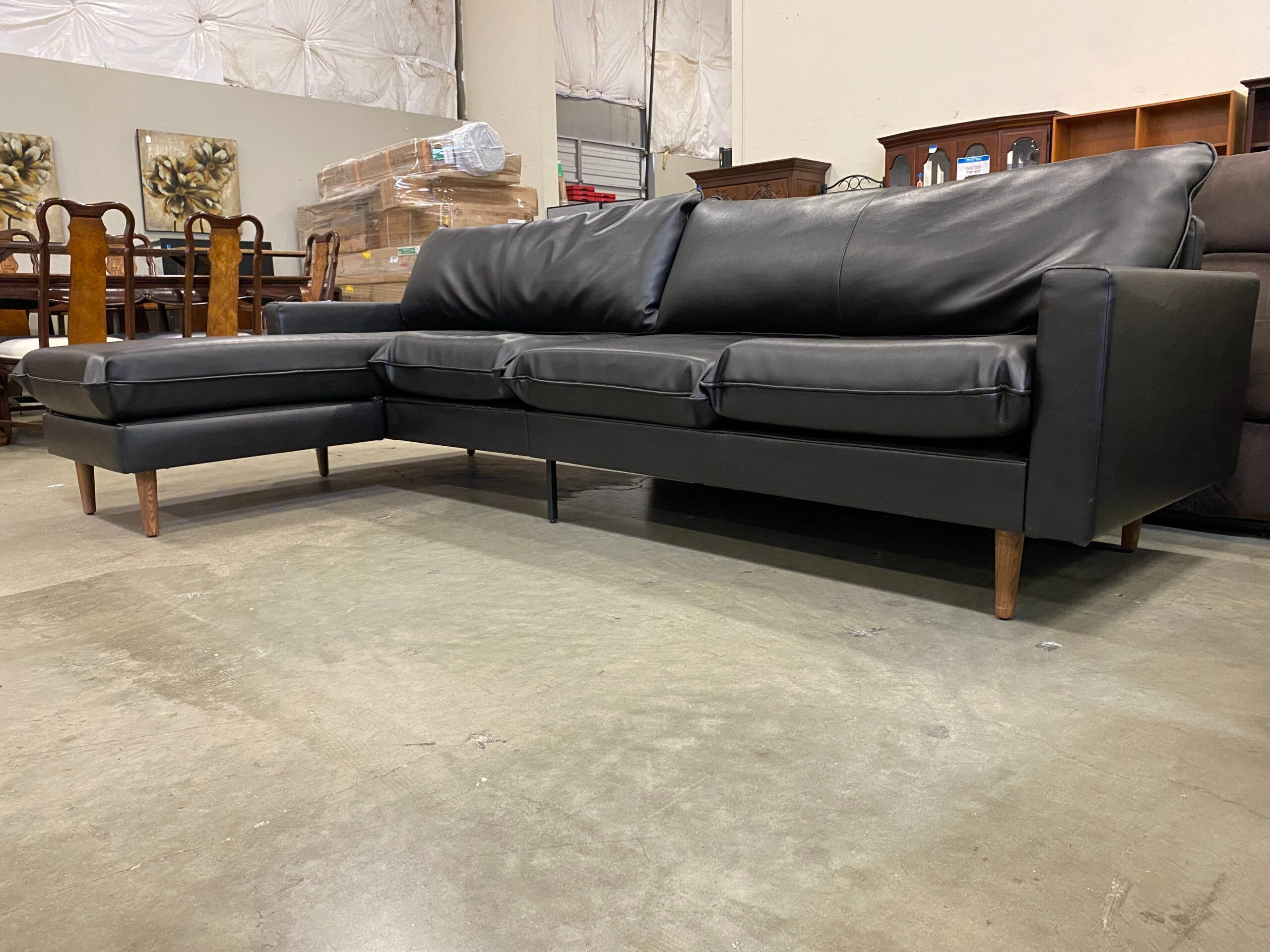 Black Leather L-Shaped Sectional with Wooden Legs