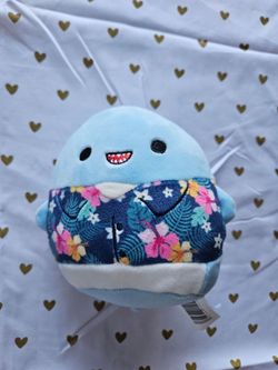 blue Squishmallows Rey the Shark wearing a tropical Hawaiian-style shirt
