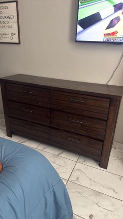 Solid wood bought it at Ashley’s furniture