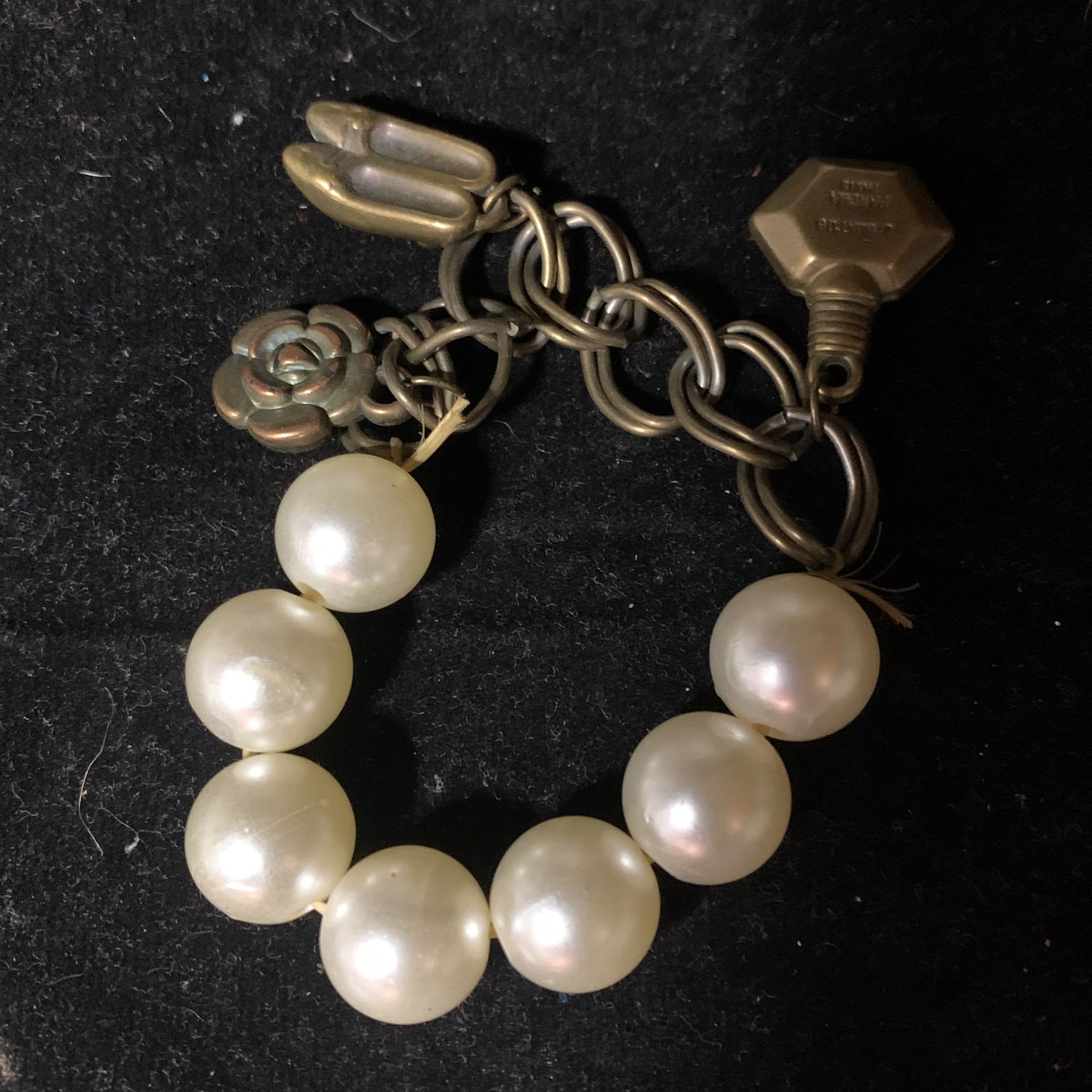 Fake pearl Bracelet with a couple charms