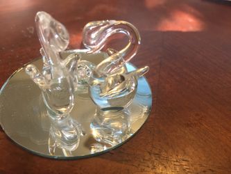 Crystal swans on a mirrored pond