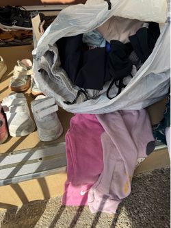 Trash bag full of kids clothes