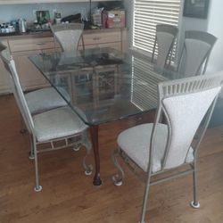 Eight Chairs And Glass Top Dinette Table 