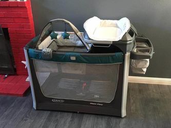 Pack and play, vibration, music, and mobile w/changing table and storage.